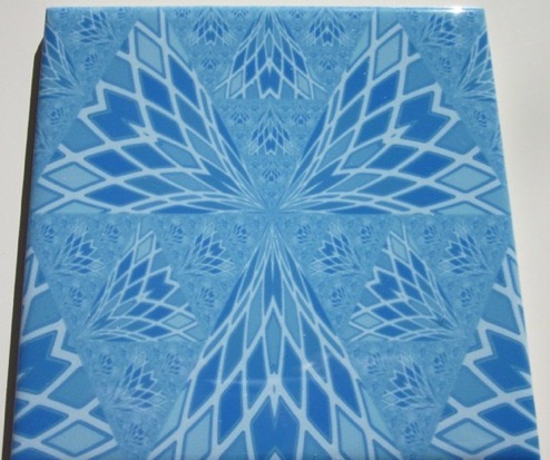 A feather like fractal in blue. Tile by Gingezel at Zazzle.